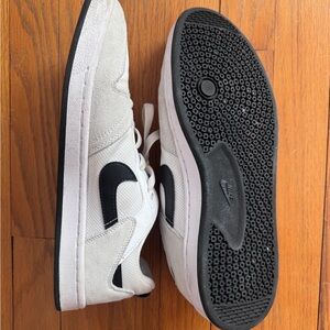Nike White Low-Top Sneakers with Black Swoosh